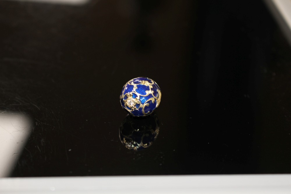 A modern 925 gilt white metal, blue enamel and diamond set egg shaped pendant, egg 20mm, gross weight 4.1 grams.